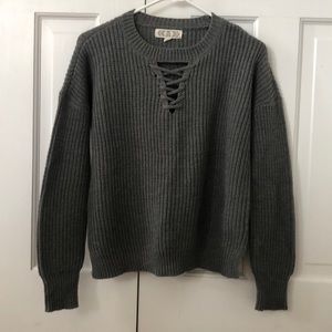A long sleeve dark gray sweater